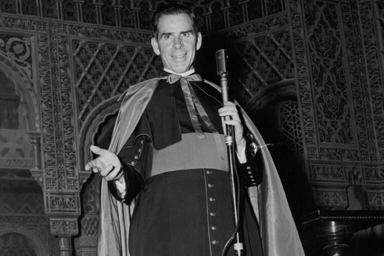 Fulton Sheen preaching in his cape at a microphone