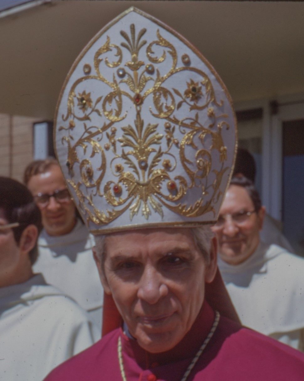 Bishop Sheen wearing an embroidered mitre, in colour