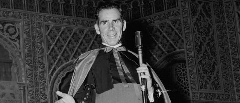 Fulton Sheen preaching at a microphone