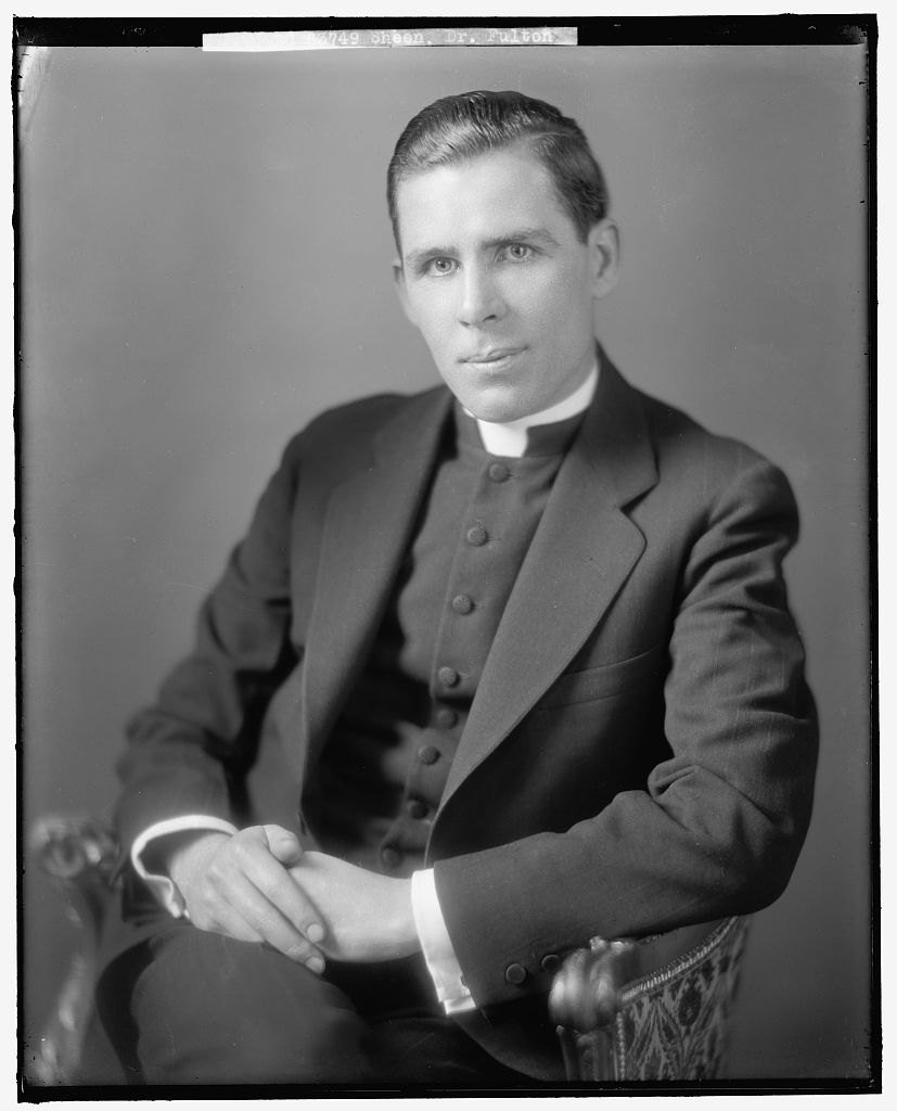 Fulton J. Sheen as a young priest, seated